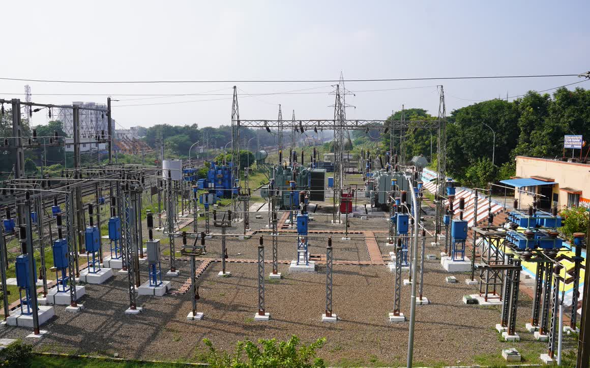 An electrical substation of the Indian Railways at Vizianagaram, rows of switchgear under transmission lines.